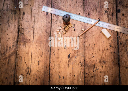 Ruler, pencil,eraser on a rustic wooden background. Conceptual image with copy space. Stock Photo