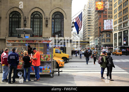 Food cart selling hot dog,pretzel and soft drink on street of midtown Manhattan, New York City,USA Stock Photo