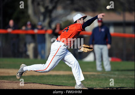 Pitcher releasing a pitch during an early spring high school non-conference game. Stock Photo