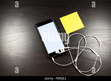 Blank notebook and smartphone with pencil on wooden table. The view from the top Stock Photo