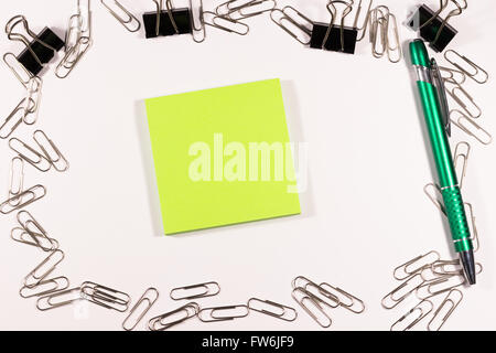 Notebook with blank paper, color sticky notes, pen and clips on a wooden table Stock Photo