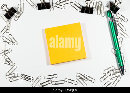 Notebook with blank paper, color sticky notes, pen and clips on a wooden table Stock Photo