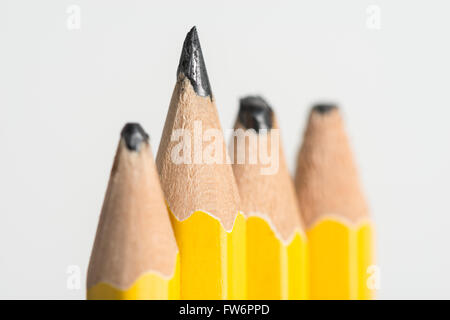 sharp and blunt pencils sigh of hard work or lazy worn pencil lead aligned in a row standing up alert Stock Photo