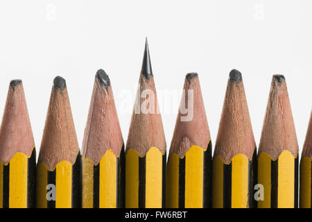 sharp and blunt pencils sigh of hard work or lazy worn pencil lead aligned in a row standing up alert Stock Photo