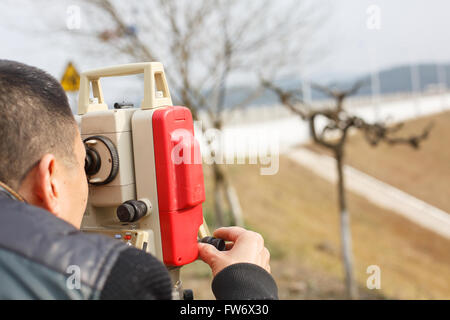 Surveyor engineer  making measure on the field Stock Photo