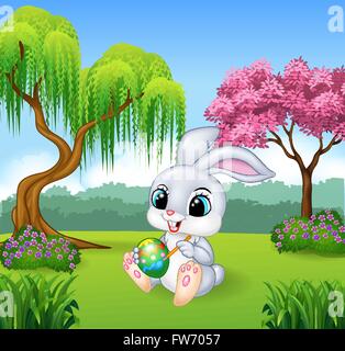 Cartoon little bunny painting an egg Stock Vector