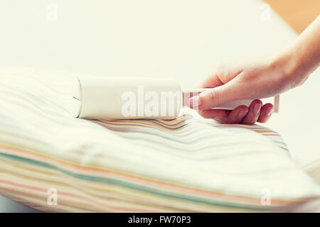 close up of woman hand with sticky roller cleaning Stock Photo