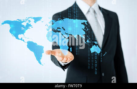 close up of man showing world map and binary code Stock Photo