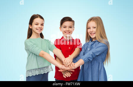 happy boy and girls with hands on top Stock Photo