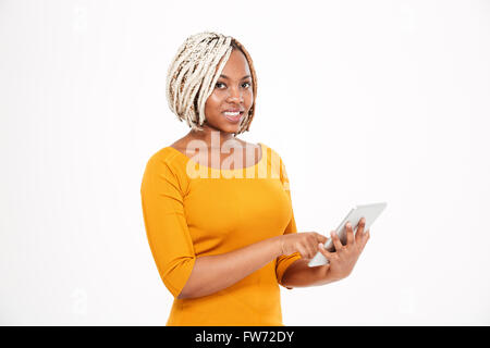 Beautiful smiling young african american woman using tablet over white background Stock Photo