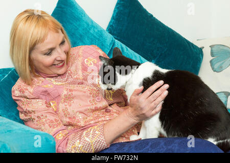 woman playing with a pet cat Stock Photo