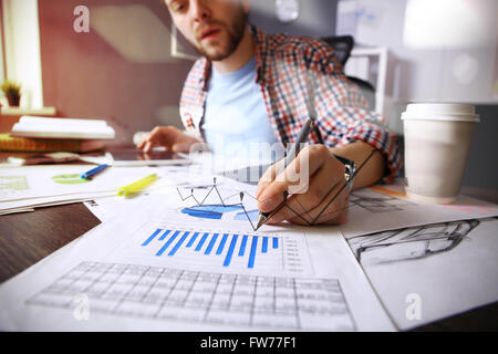 business documents on office table with smart phone and digital tablet and graph business with social network diagram and man working Stock Photo