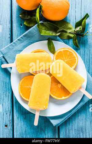 natural juice orange popsicle, from above on wooden rustic table Stock Photo