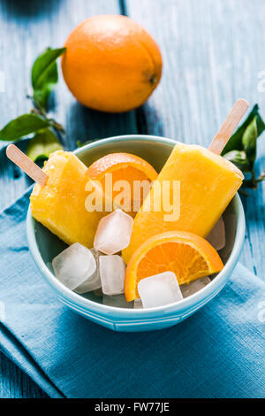Homemade lilly pops in bowl with fruits, on wooden rustic table Stock Photo