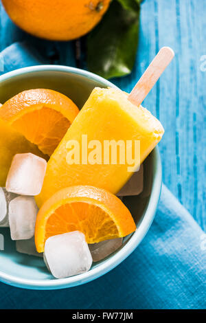 Homemade lilly pops in bowl with fruits, on wooden rustic table Stock Photo