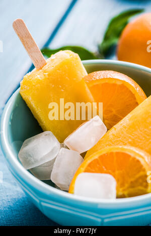 Homemade lilly pops in bowl with fruits, on wooden rustic table Stock Photo