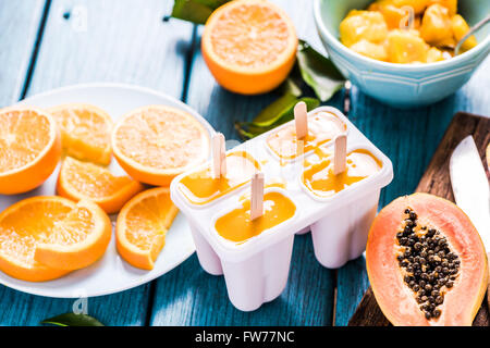 Refreshing treat, exotic fruits lolly, popsicle with ingredients Stock Photo
