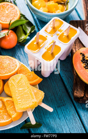 Natural juice and ingredients homemade popsicle, on wooden table Stock Photo