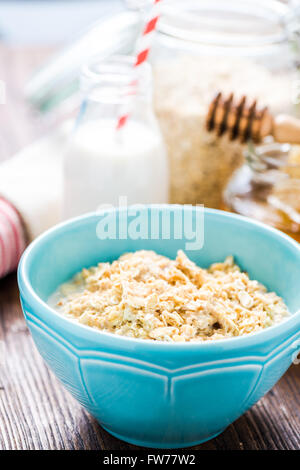 Healthy breakfast, porridge in bowl. Jar with honey in background Stock Photo