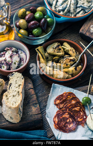 Sharing authentic spanish tapas with friends in restaurant or bar. View from above. Stock Photo