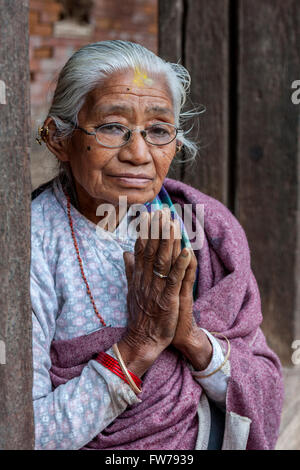 Bhaktapur, Nepal.  Old Newari Woman Making Namaste Gesture of Greeting. Stock Photo