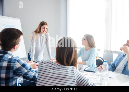 Delighted team sitting  discussing the project Stock Photo