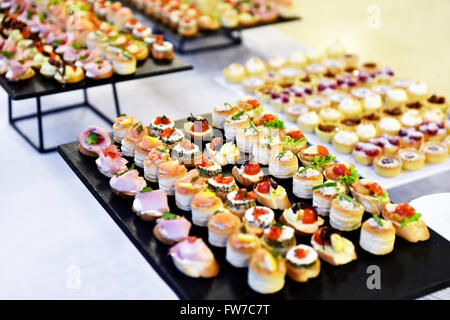 Catering food shot with small appetizers on plates ready for eat Stock Photo