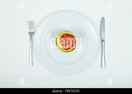 Red apple and measuring tape on plate Stock Photo
