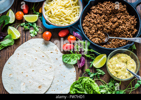 Mexican street simple street food, tortillas with minced beef and guacamole. Stock Photo