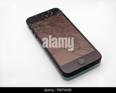 Los Angeles, CA, USA - December 07, 2015: Broken Apple iPhone with cracked screen on white background, selective focus Stock Photo