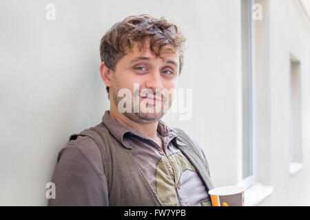 Headshot of a smiling curly-haired young man Stock Photo