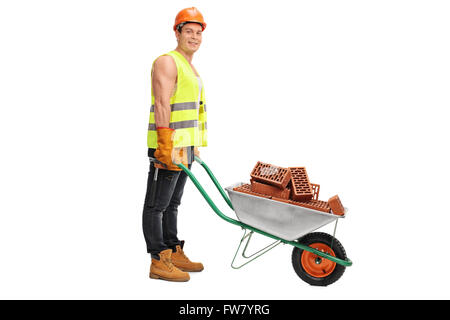 Construction worker posing with a wheelbarrow full of bricks isolated on white background Stock Photo