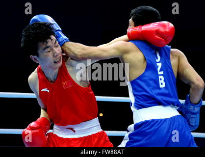 Qian'an, China's Hebei Province. 1st Apr, 2016. Hu Jianguan (L) of China competes against Shakhobidin Zoirov of Uzbekistan during the final match of the men's 52kg category competition at the Asia/Oceania Zone boxing event qualifier for 2016 Rio Olympic Games in Qian'an, north China's Hebei Province, April 1, 2016. Credit:  Yang Shiyao/Xinhua/Alamy Live News Stock Photo