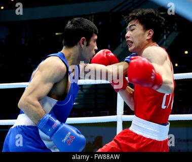 Qian'an, China's Hebei Province. 1st Apr, 2016. Hu Jianguan (R) of China competes against Shakhobidin Zoirov of Uzbekistan during the final match of the men's 52kg category competition at the Asia/Oceania Zone boxing event qualifier for 2016 Rio Olympic Games in Qian'an, north China's Hebei Province, April 1, 2016. Credit:  Yang Shiyao/Xinhua/Alamy Live News Stock Photo