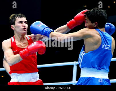 Qian'an, China's Hebei Province. 1st Apr, 2016. Olzhas Sattibayev (L) of Kazakhstan competes against Azat Usenaliev of Kyrgyzstan during the bronze medal match of the men's 52kg category competition at the Asia/Oceania Zone boxing event qualifier for 2016 Rio Olympic Games in Qian'an, north China's Hebei Province, April 1, 2016. Credit:  Yang Shiyao/Xinhua/Alamy Live News Stock Photo