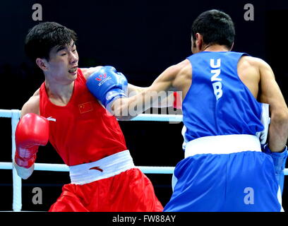 Qian'an, China's Hebei Province. 1st Apr, 2016. Hu Jianguan (L) of China competes against Shakhobidin Zoirov of Uzbekistan during the final match of the men's 52kg category competition at the Asia/Oceania Zone boxing event qualifier for 2016 Rio Olympic Games in Qian'an, north China's Hebei Province, April 1, 2016. Credit:  Yang Shiyao/Xinhua/Alamy Live News Stock Photo