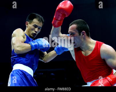 Qian'an, China's Hebei Province. 1st Apr, 2016. Erkin Adylbek Uulu (L) of Kyrgyzstan competes against Aziz Achil Ov of Turkmenistan during the bronze medal match of the men's 81kg category competition at the Asia/Oceania Zone boxing event qualifier for 2016 Rio Olympic Games in Qian'an, north China's Hebei Province, April 1, 2016. Credit:  Yang Shiyao/Xinhua/Alamy Live News Stock Photo