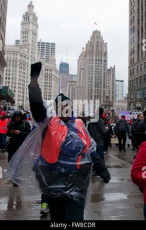 Chicago, USA. 1st Apr, 2016. A woman shouts slogans during a rush-hour rally for a demonstration against budget and program cuts in Chicago, the United States, April 1, 2016. The Chicago public school teachers and their supporters held a one day strike, named the 'Day of Action' on Friday to protest against budget and program cuts, forcing the cancellation of classes for more than 300,000 students, according to local media. Credit:  He Xianfeng/Xinhua/Alamy Live News Stock Photo