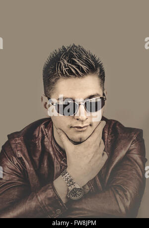 young handsome man posing in sunglasses Stock Photo