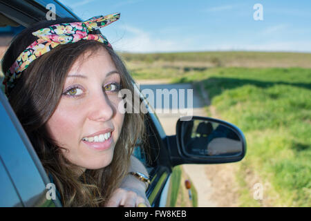 Woman looking thru car window on a road trip Stock Photo