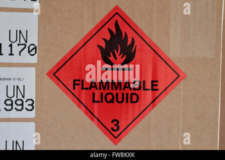 A flammable liquid hazchem warning label & multiple UN ID labels on the packaging of a delivery of chemicals to a UK high school Stock Photo