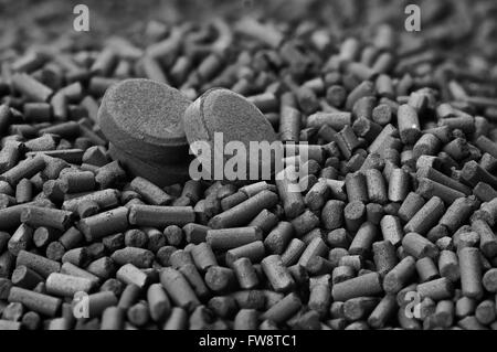 Activated carbon granules and tablets close up Stock Photo