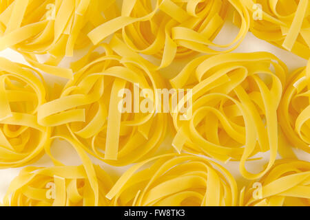 Dried ribbons of pasta coiled into nests Stock Photo