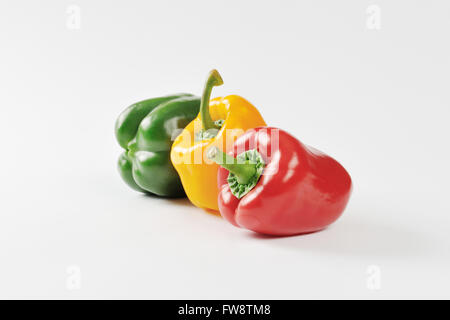 Three fresh bell peppers - red, yellow and green Stock Photo