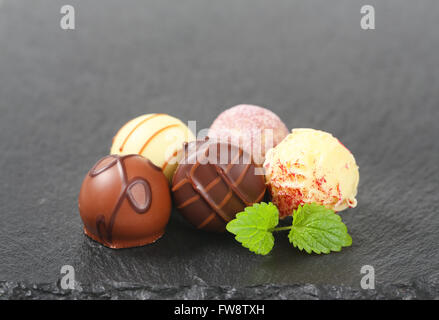 assorted belgian chocolate pralines on black background Stock Photo
