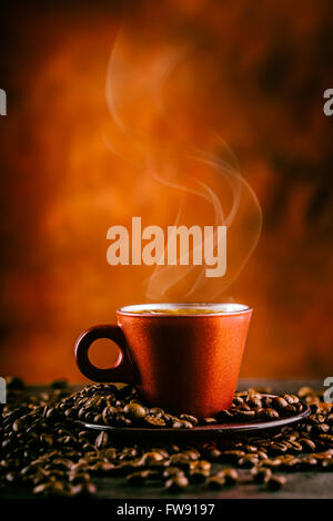 Coffee. Cup of black coffee and spilled coffee beans. Coffee break. Stock Photo