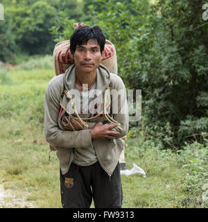 A man is carrying a sack on his back, a basket and wooden spoons in his  hand. Coloured engraving Stock Photo - Alamy