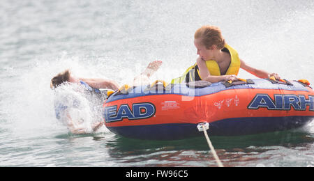 Tubing on Lake Jocassee during pontoon boat tour of the waterfalls in Upstate South Carolina. Stock Photo