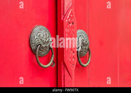 door knockers on the red door Stock Photo