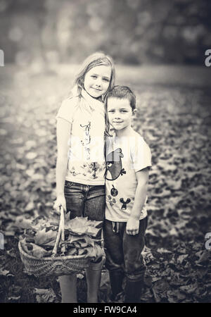 two children standing in autumn forest Stock Photo
